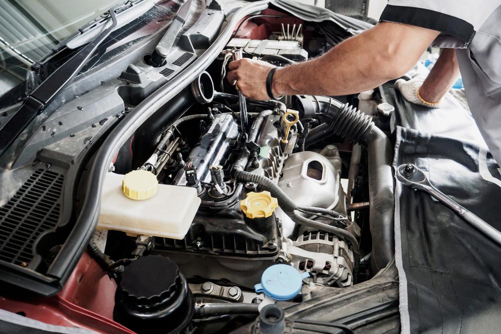Mechanic Inspecting A Car Engine