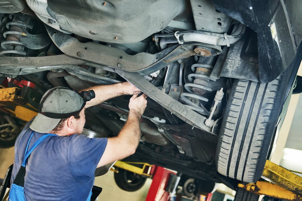 A Professional Mechanic Repairing A Vehicle Suspension